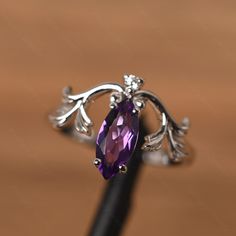 It is a amethyst ring. The main stone is 5 mm* 10 mm marquise cut.weight about 0.87 carats. The basic metal is sterling silver and plated with rhodium. To change the metal to a solid gold (white/rose) or platinum is also available, please ask for a quotation if you want. You can also go to my shop Home for more elegant rings: https://www.etsy.com/shop/godjewelry?ref=hdr_shop_menu Alexandrite is June birthstone More alexandrite rings: https://www.etsy.com/shop/godjewelry?ref=seller-platform-mcnav Purple Marquise Cut Amethyst Promise Ring, Purple Amethyst Promise Ring In Marquise Shape, Purple Marquise Amethyst Promise Ring, Marquise Amethyst Ring With Prong Setting, Purple Marquise Amethyst Ring With Prong Setting, Alexandrite Rings, February Birthstone Ring, Elegant Rings, Alexandrite Ring