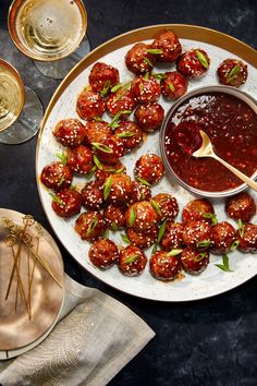 a white plate topped with meatballs covered in sauce