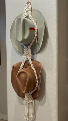 a hat is hanging on the wall next to a purse