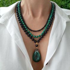 Black onyx and malachite crystal layered necklace with pendant. Chunky statement natural gemstone beaded necklace for women. Large black green handmade necklace with big bead and gemstone. Big bold bohemian bright necklace in gold color are suitable for an casual look, evening look and for a holiday. These necklace will be a good Mothers day, anniversary, wedding or birthday gift for women, mom, wife, girlfriend, sister or daughter. Women's necklace with natural stone. It emphasizes the beauty o Luxury Elegant Green Onyx Beaded Necklace, Elegant Onyx Crystal Necklaces With Natural Stones, Elegant Handmade Double Strand Crystal Necklaces, Elegant Handmade Double Strand Crystal Necklace, Elegant Agate Beaded Pendant Necklaces, Elegant Agate Pendant Beaded Necklaces, Onyx Round Beads Jewelry, Elegant Multi-strand Crystal Gemstone Necklaces, Elegant Handmade Multi-strand Crystal Necklaces