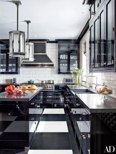 a black and white kitchen with stainless steel appliances