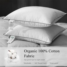 two pillows are stacked on top of each other with the label organic 100 % cotton fabric