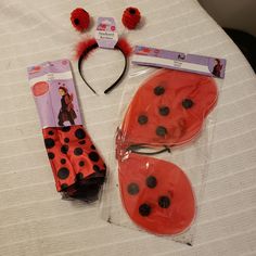 the ladybug costume and accessories are laying on top of the bed, ready to be worn