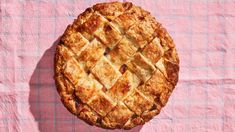 a pie sitting on top of a pink table cloth