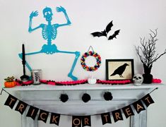 a mantle with halloween decorations on it and a skeleton decoration above the mantelpiece