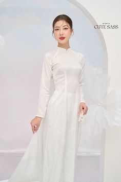 "\"Tinh\": white, pure, elegant \"Kỳ\": sophisticated \"Tinh Kỳ\" collection centers around white áo dài, featuring designs ranging from simple to sophisticated. Whether you need a white áo dài for a casual or special occasion, there is one for you. Each design is made of high-quality materials, embodying so much detail to create a style that is both subtle and distinctive. As always, our focus lies on elegance, quality, and size inclusivity.  ❣️ This set includes one Ao Dai Top and Pants Style: Traditional  Material: Silk. Some Stretch  Model wears size S ❣️ Please note: - Sizing may run smaller than American standard sizes, please refer to the sizing charts. - Please contact us if you have any questions ❣️We are proud to provide you with the highest quality fabric, handpicked modest colo Elegant Stretch Wedding Sets, Elegant Stretch Sets For Wedding, Elegant White Ao Dai For Formal Occasions, Solid Color Sets For Spring Wedding, Traditional White Ao Dai For Formal Occasions, White Stretch Long Sleeve Set, White Stretch Sets With Long Sleeves, Traditional White Long Sleeve Ao Dai, White Fitted Ao Dai For Summer