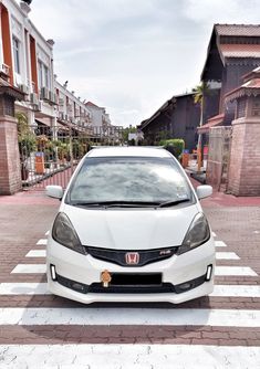 a white car is parked on the street