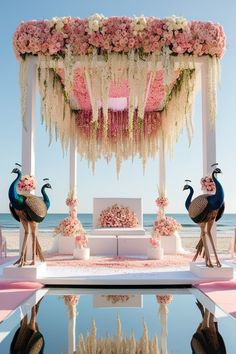 an outdoor wedding setup with flowers and peacocks