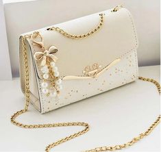 Style:Fashionable Features:Waterproof Color:Beige Details:Bow, Pearls, Grommet Eyelet Bag Size:Small Closure Type:Flap Pattern Type:Colorblock, Geometric, All Over Print Strap Type:Chain Type:Square Bag Composition:100% Polyurethane Material:PU Leather Fancy Clutch Purse, Fancy Clutch, Rhinestone Handbags, Trendy Purses, Prom Inspo, Bags Ideas, Trendy Bags, Tas Bahu, Wedding Bags