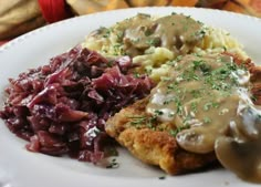 a plate with meat, mashed potatoes and gravy