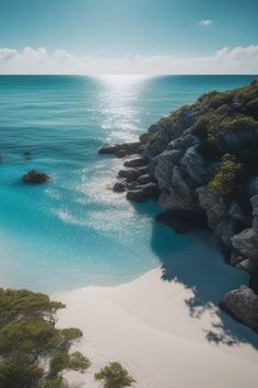 an aerial view of the ocean with rocks and water