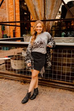 We think spooky graphic tees should be a thing all year round. If you agree, then we think you’ll love our Don’t Look Back Graphic Tee. A grey shirt with black graphic of a skeleton looking back in the rearview mirror. Pair it with some flare jeans for a spooky inspired casual look! Gray Grunge T-shirt For Fall, Grunge Washed Black T-shirt For Fall, Boot Pattern, Spooky Graphic Tees, Cowgirl Look, Don't Look Back, Rhinestone Fringe, Boots Patterns, Black Denim Skirt