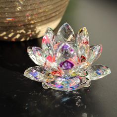 a crystal flower sitting on top of a table