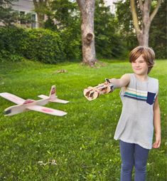 a young boy is playing with a toy plane