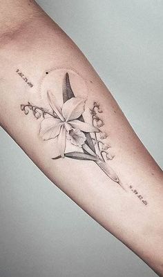 a woman's arm with a tattoo on it that has flowers and words written in cursive writing