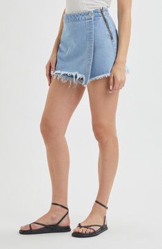 Keep it carefree and kicked back when you choose a look that combines the comfort of cutoff shorts with the cuteness of a denim mini. 3 1/2" inseam; 26" leg opening; 12" front rise; 14 1/2" back rise (size 29) 15" length (size 29) Exposed side-zip closure; wrap front with button Back patch pockets 100% cotton Machine wash, line dry Imported Spring Denim Skort With Built-in Shorts, Denim Skort With Built-in Shorts For Spring, Denim Skort With Built-in Shorts For Summer, Trendy Cutoff Denim Skirt With Built-in Shorts, Medium Wash Mini Bottoms For Day Out, Medium Wash Mini Length Bottoms For Day Out, Spring Medium Wash Denim Skirt With Built-in Shorts, Summer Denim Skort For Day Out, Day Out Mini Length Medium Wash Bottoms