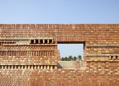 a brick wall with an open window in it