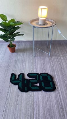 a floor mat with the number twenty five on it next to a potted plant