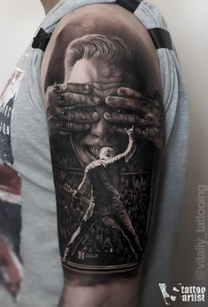 a man's arm with a tattoo on it that has an image of a person holding