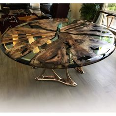 the table is made out of wood and has an unusual design on it's glass top