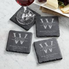 four personalized slate coasters with wine glass and cheese on the table next to them