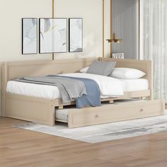 a bed with two drawers underneath it in a room