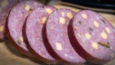 several slices of salami sitting on top of a cutting board