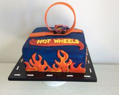 there is a cake that says hot wheels on the top and flames in the bottom