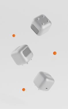 three air freshener dispensers floating in the air with orange dots around them