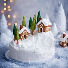 there is a cake decorated with houses and trees