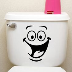 a toilet with a funny face drawn on it