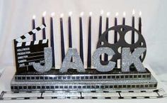 a black and white cake with candles in the shape of letters that spell out jack