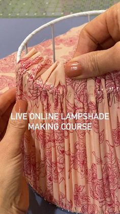 two hands are holding a piece of fabric with the words live online lampshade making course