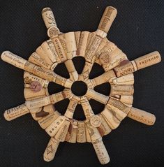 a bunch of wine corks are arranged in a circular pattern on a black surface