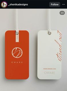 two tags hanging from the side of a white and orange wall with red lettering on them