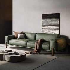 a living room with a green leather couch and coffee table