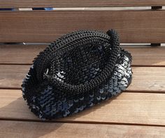 "Meet Black, the noble member of our Crochet Sequin Bag collection that fascinates with its sparkle! Our Handmade Black Evening Purse, which stands out among the clutch bags that are indispensable for every woman, is crocheted by combining each sequin with individual weaving.  Our metallic bag, which is a candidate to be the most elegant and powerful part of your wardrobe, allows you to buy 2 different Black crochet bags in one selection with its detachable asymmetric strap. Moreover, the other colours are great too!   * If you want to see all our Crochet Sequin Bags, they are all at this link: https://www.etsy.com/shop/HandicrafthobbiesBag?ref=seller-platform-mcnav&section_id=45778896 The removable knitted strap is planned in sizes suitable for both shoulder and hand carrying. It is conne Handmade Black Handheld Evening Bag, Handmade Black Clutch Evening Bag, Handmade Black Party Bag, Handmade Black Evening Bag, Black Crochet Bag For Party, Elegant Black Crochet Bag For Evening, Black Handmade Evening Bag For Party, Black Crochet Clutch For Evening, Black Crochet Clutch Bag For Evening