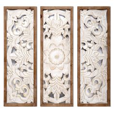 three panels with carved designs on them, one in white and the other in brown