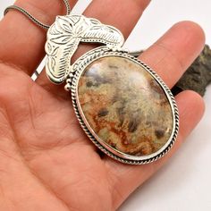 "Crazy lace agate necklace sterling silver large oval lace agate pendant orange brown beige antique bohemian style, artisan boho jewelry A beautiful large oval crazy lace agate stone with hues of brown, beige and orange in sterling silver statement pendant. Lovely autumn colors and winter colors too. The stone is set inside a bezel and framed with braided wire . On top of it there is an engraved antique floral pattern. I have oxidized it to bring out the details and achieved this bohemian look T Earthy Brown Round Pendant Jewelry, Artisan Brown Necklace With Oval Pendant, Bohemian Oval Pendant Necklace With Cabochon, Antique Brown Agate Jewelry, Bohemian Pendant Necklace With Large Stone, Bohemian Oval Agate Necklace, Bohemian Pendant Jewelry With Large Stone, Earthy Handmade Silver Jewelry, Handmade Earthy Silver Jewelry