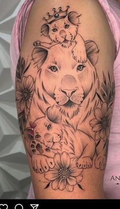 a woman's arm with a tiger and flowers tattoo on the left side of her body