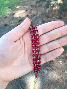 Opaque Red handmade lentil bracelet. I stitched this bracelet using a needle and fireline beading thread. It is made with red two hole lentil beads and size 15 seed beads. This bracelet is 7 and 3/4 inches long and 1/2 an inch wide. Metal free, and perfect for people with allergies to copper, iron, gold, or silver! :)   Materials *czech beads *fireline  *seed beads (size 15) *two hole lentil beads  Feel free to message me with any questions about this product Adjustable Red Friendship Bracelets With Spacer Beads, Red Crystal Bracelet With Spacer Beads, Handmade Red Braided Bracelets For Festival, Red Bracelets With Tiny Round Beads, Adjustable Red Friendship Bracelets, Handmade Red Bohemian Crystal Bracelet, Handmade Bohemian Red Crystal Bracelet, Red Handmade Braided Bracelets With Round Beads, Handmade Red Braided Bracelets With Round Beads