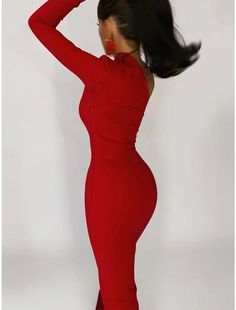 a woman in a red dress is posing for the camera with her hair blowing back