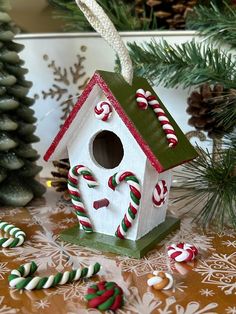 a birdhouse decorated with candy canes and candies