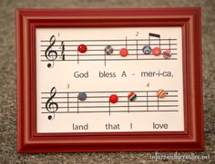 a red frame with music notes and magnets on it that says god blessing america, land that i love