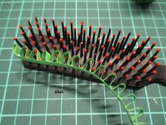 a close up of a hair brush on a table with green and red lines around it