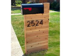 a wooden mailbox with the number 2234 written on it