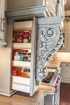 an open cabinet in the middle of a kitchen