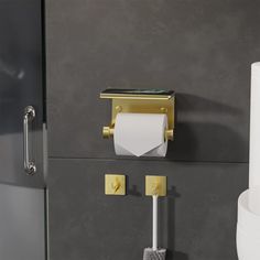 a toilet paper dispenser and two rolls of toilet paper