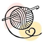 a ball of yarn with a knitting needle in the center and a heart on it