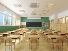 an empty classroom with wooden desks and green walls